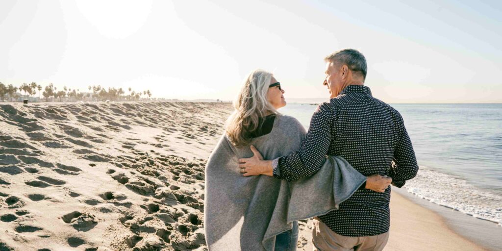 man and woman walking on the beach image for Our Children No Longer Need to Worry About Our Cognitive Decline article